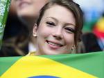 Com bandeiras e objetos, mulheres se acomodam na torcida brasileira