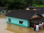 Rio Itaja-Mirim transborda e invade casas no bairro Limoeiro. Alguns moradores ainda estavam tirando seus pertences