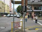Pedestres atravessam a rua com o sinal aberto para os veculos