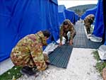 Soldados italianos revestem os caminhos do acampamento para desabrigados nas cercanias de L'Aquila