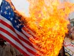 Seguidores do partido religioso Tanzeem Ehl-e-Sunnat queimam uma bandeira dos Estados Unidos em protesto contra a extino da lei que castiga a blasfmia em Lahore, no Paquisto